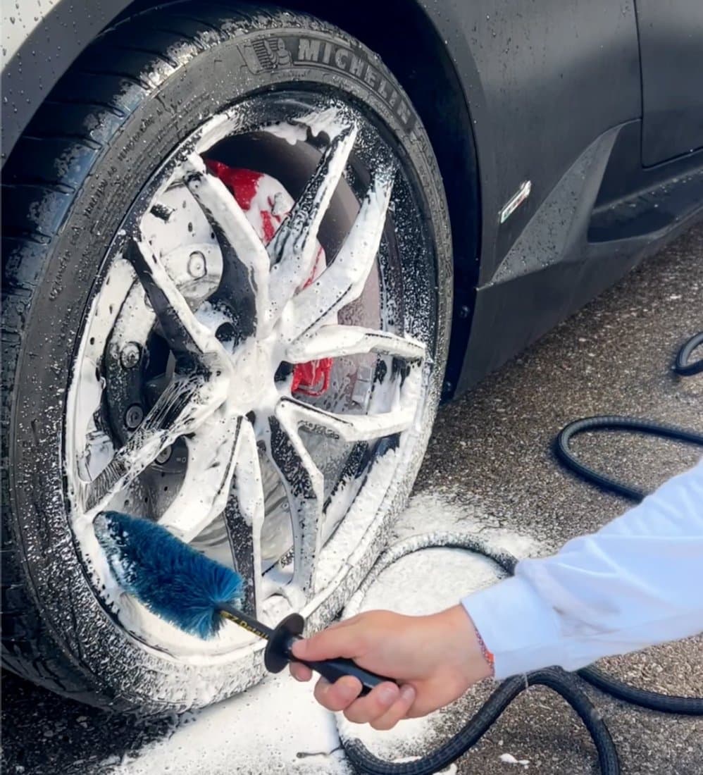 Wheel foam cleaning with brush