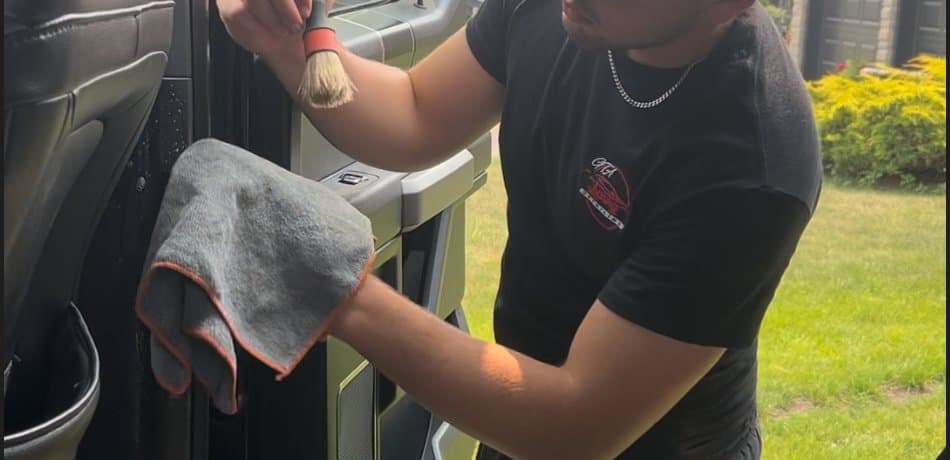 Wiping door panel with microfiber cloth