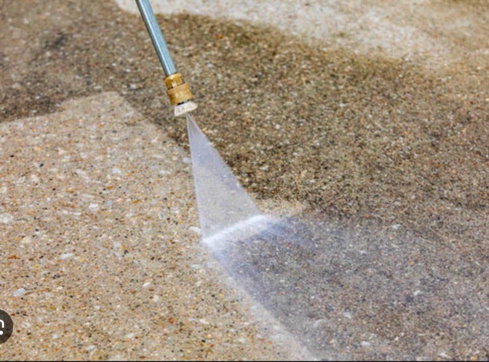 Professional pressure washing driveway and vehicle